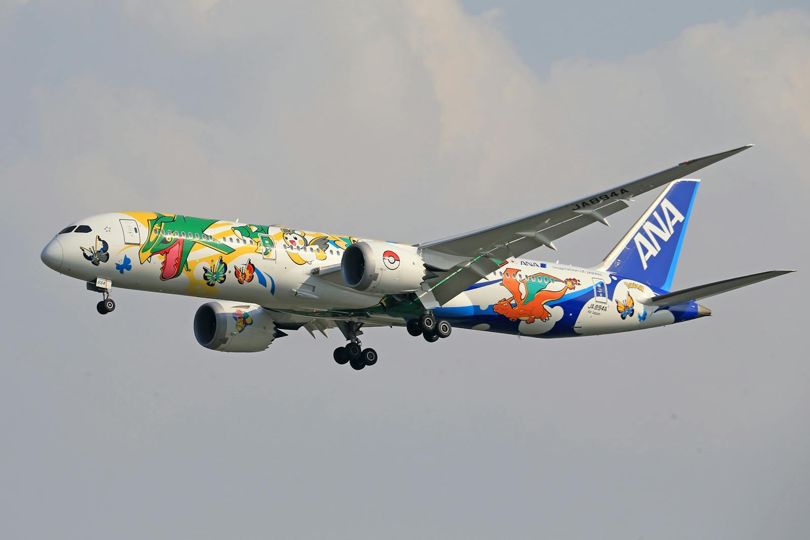 ANA airplane decorated with Pokémon artwork in flight, showcasing vibrant character designs.