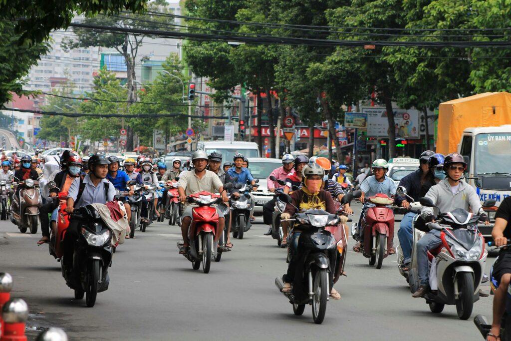 a group of people riding motorcycles down a street