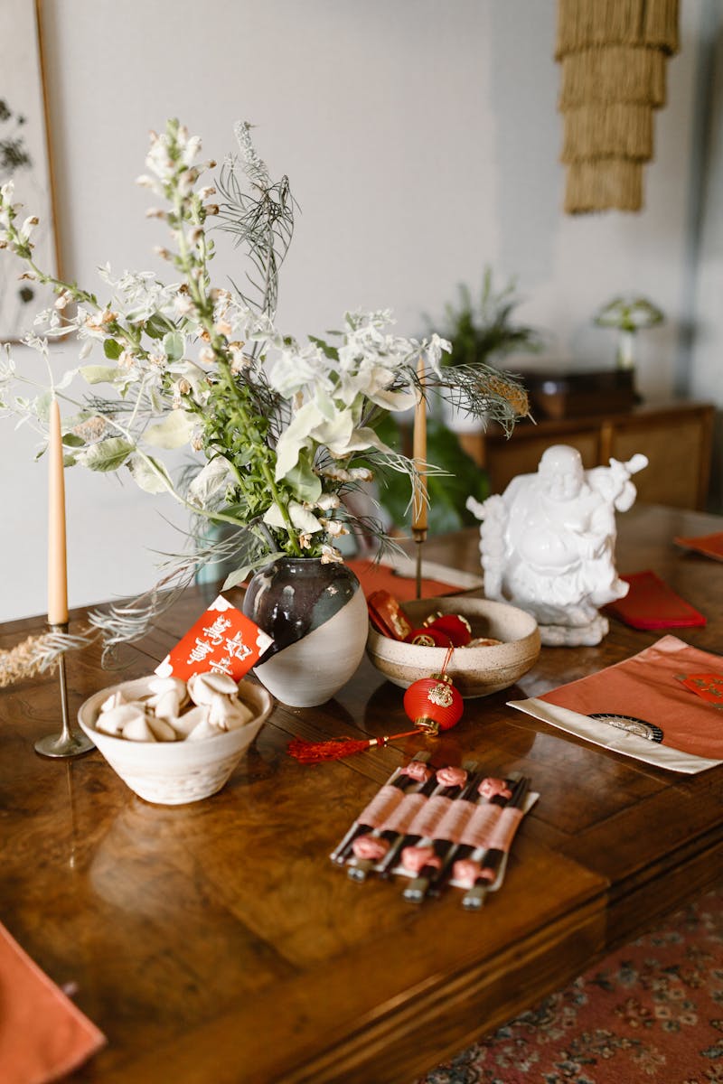 A beautifully arranged table for Chinese New Year with decorations and traditional items.