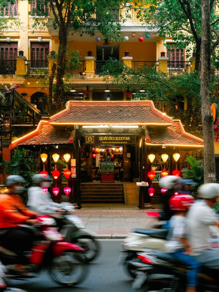 A group of people riding motorcycles down a street