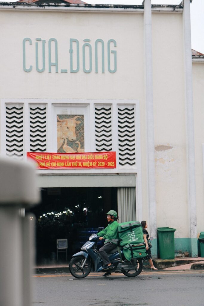 man in green jacket sitting on green plastic chair