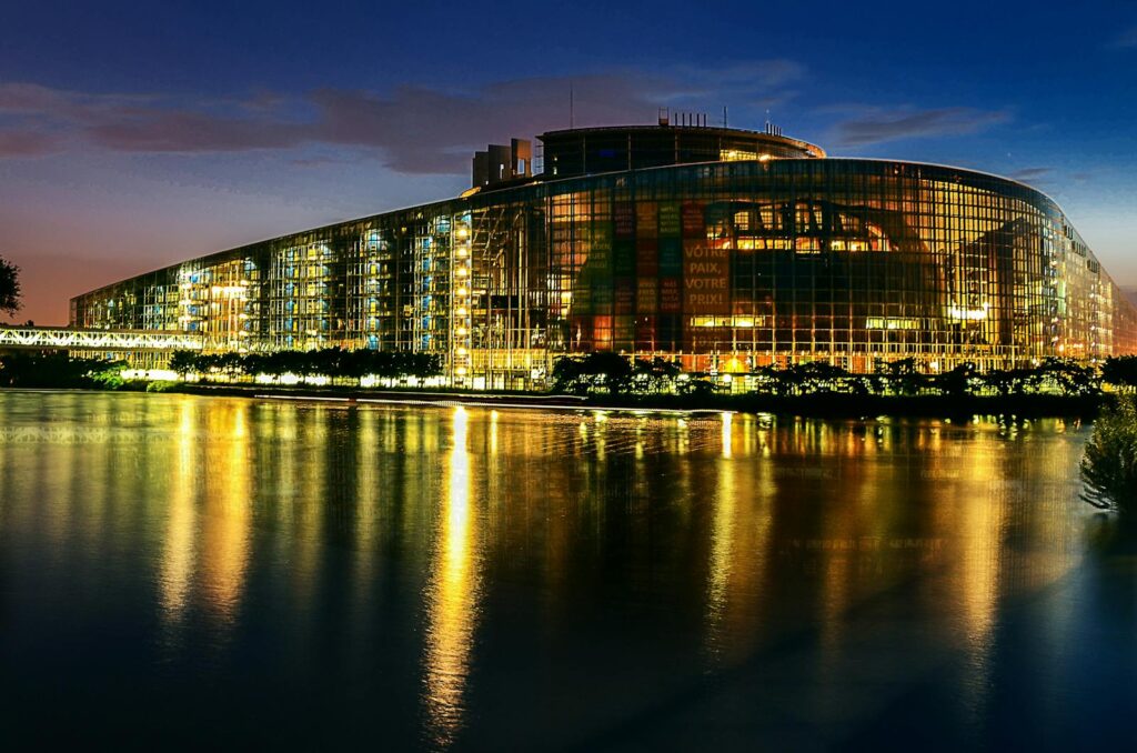 Stunning night view of the European Parliament in Strasbourg, beautifully reflected in the water.