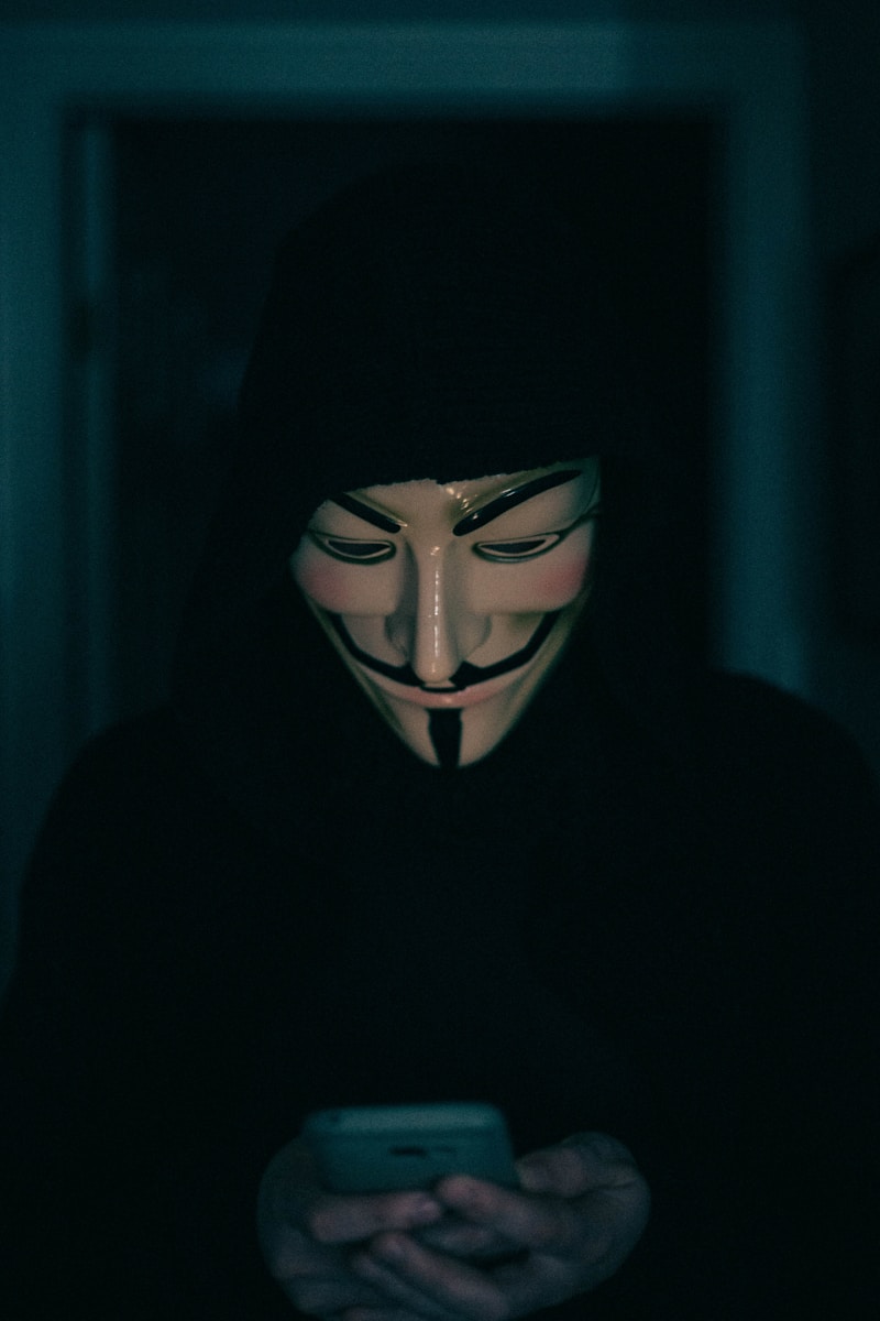 a person wearing a mask using a cell phone