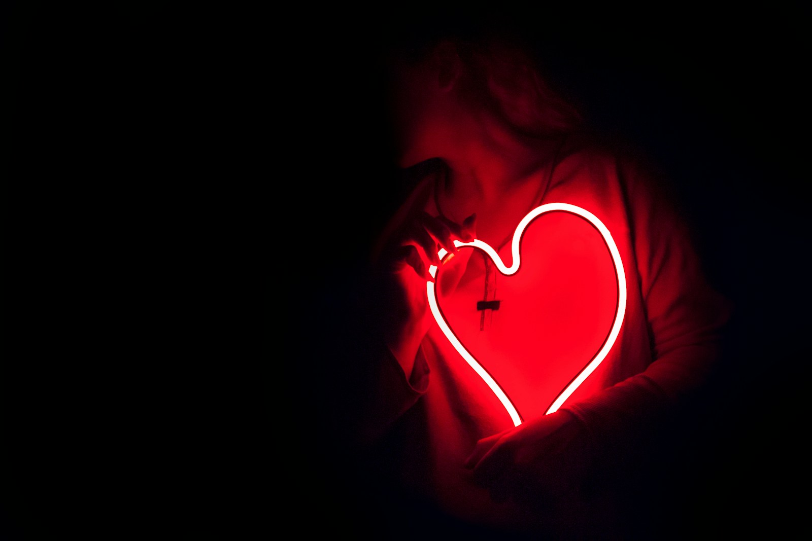 Fostering Connections in Translation a heart shaped neon sign in the dark