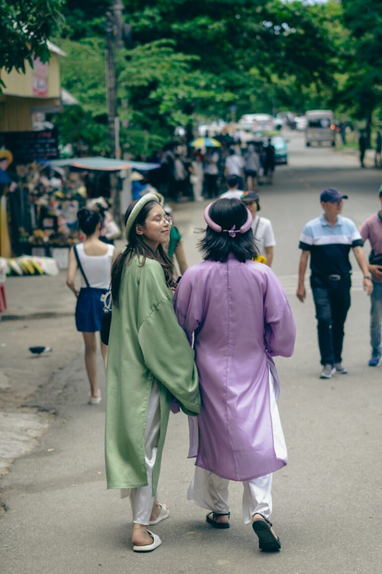 A couple of people walking down a street
