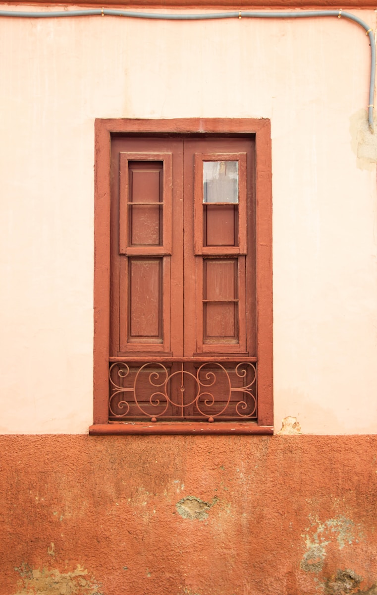The Last Kilns of Vinh Long: One Man’s Fight to Keep a Fire Burning Brown door on white concrete wall