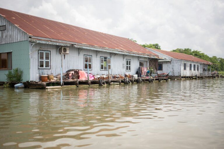 A row of houses sitting next to a body of water