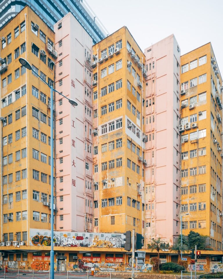 A very tall yellow building with lots of windows