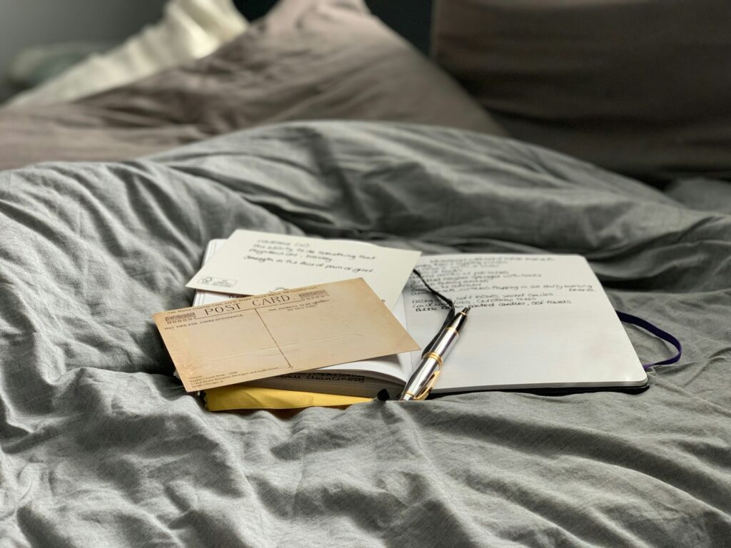 Brown and white book on gray textile ready to write.