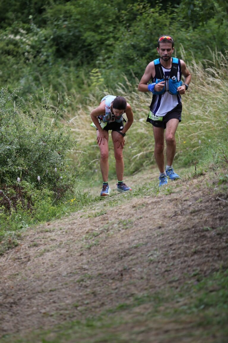 Two men running on hill