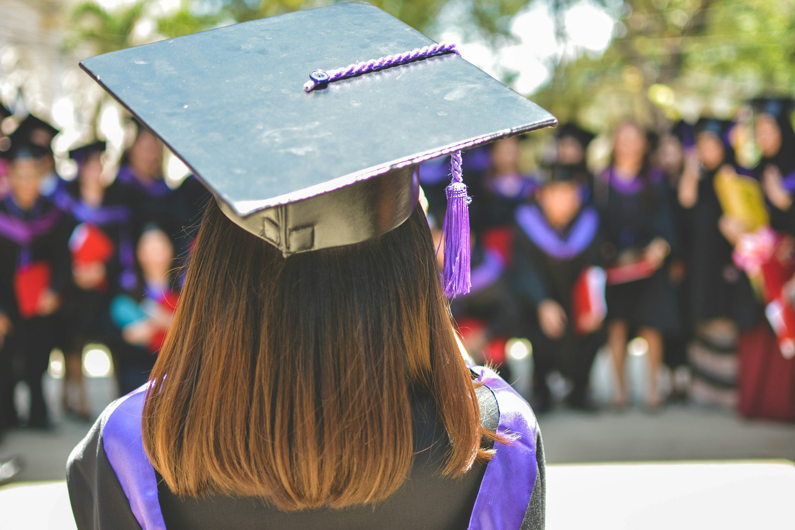 A woman wearing academic cap and dress selective focus photography