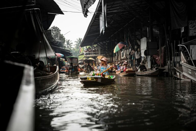 A group of people riding on top of a boat down a river