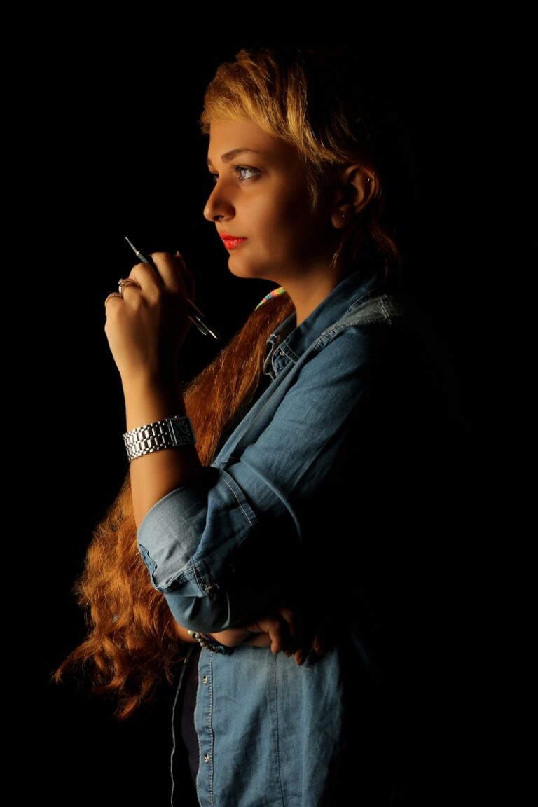 A young woman writer in black long sleeve shirt smoking cigarette