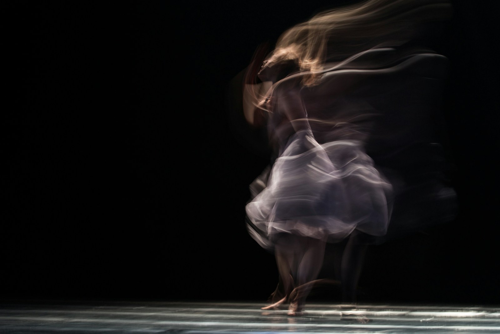 Dancing woman on concrete pavement