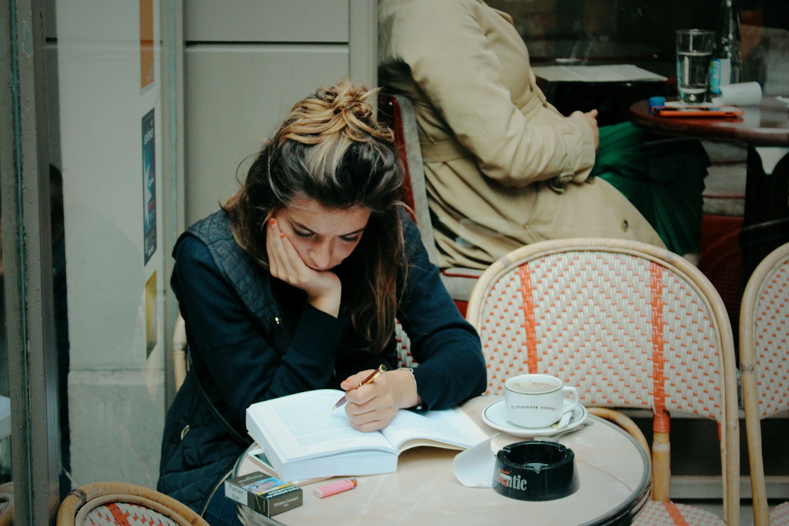 A woman in black jacket sitting on chair