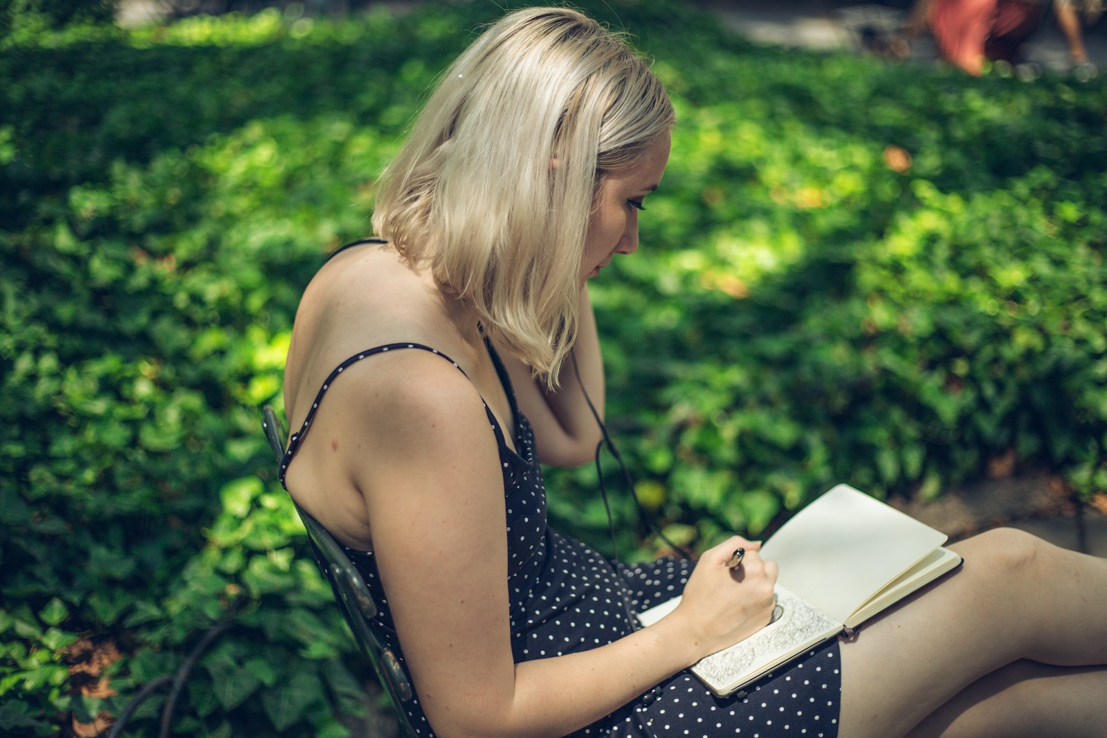 A woman writing on notebook