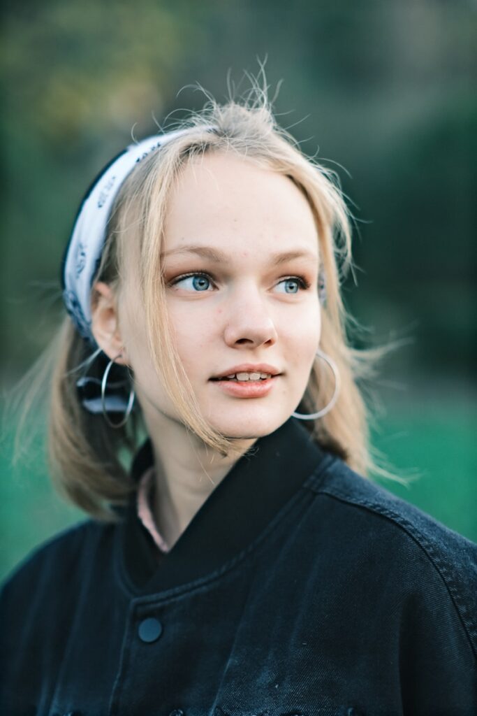 A young woman with blue eyes wearing a black jacket