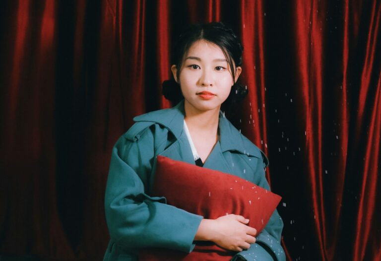 A young Woman holding a red folder