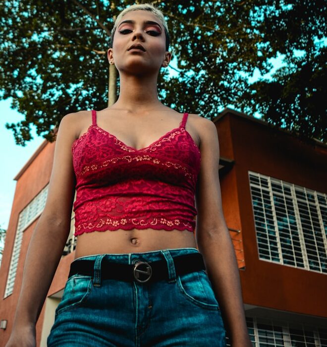 woman standing under green tree during daytime
